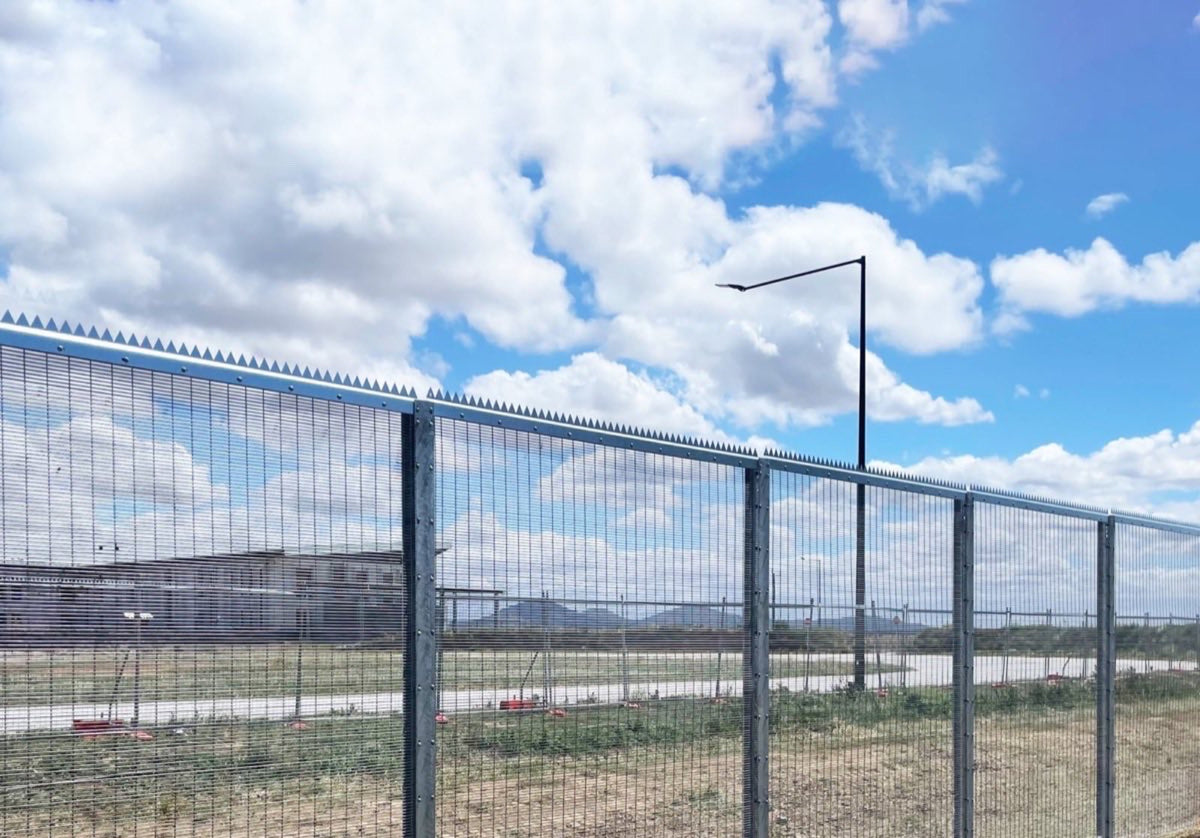 Anti climb spikes fitted to the top of a mesh security fence